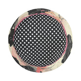 Top view of a round black and white polka dot bucket hat with Asian floral brim on a white background