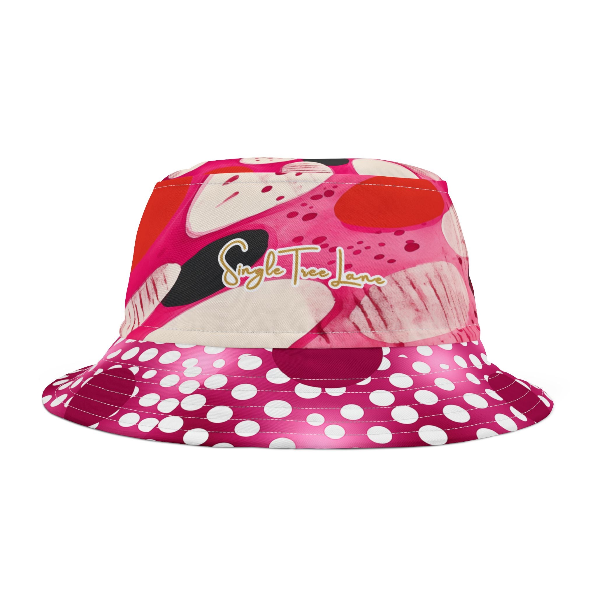 Side view of a pink bucket hat with polka dot brim and colorful design on a white background